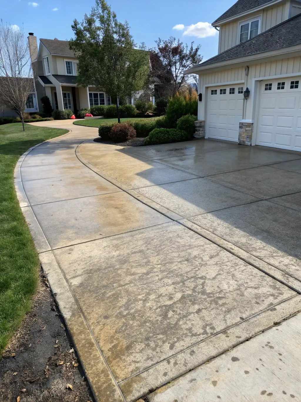 A before-and-after photo of a driveway cleaned by The Foam Theory, demonstrating the visible improvement and quality of their work.